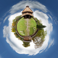 The historic church enclosed by a wooden fence.