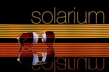 Solarium and sunglasses poster colorful lines black background