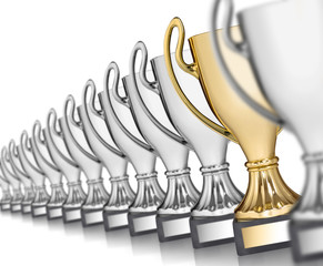 Row of silver trophies and one gold isolated on white