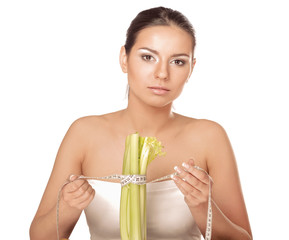 Young woman with vegetables and measuring tape