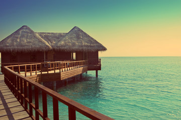 Maldives.Villa on piles on water ,with a retro effect