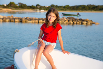 Kid girl pretending to be sailor in boat bow at Formentera