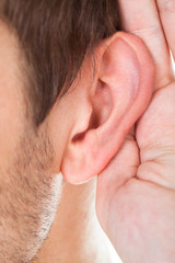 Close-up Of Hand Near Ear