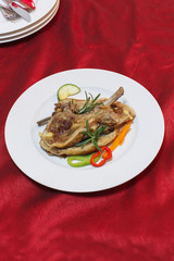 Grilled lamb ribs on white plate