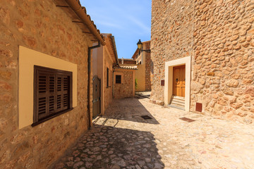 Fototapeta na wymiar Stone houses on street of Fornalutx village, Majorca island