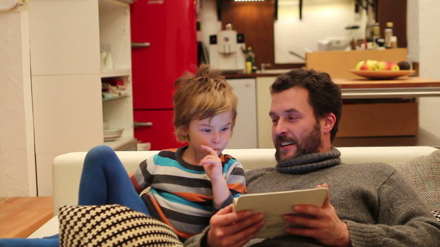 Father and Son with digital tablet at home
