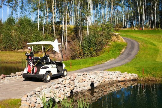 Golf-cart car on bridge in golf course