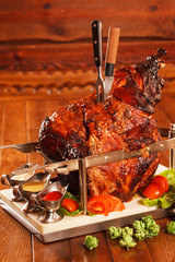 huge chunks of pork roasting on a spit