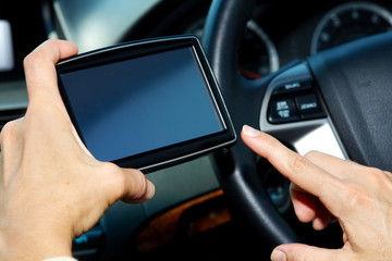 Car driver hands with GPS.
