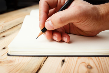 In Search Of Inspiration. A man with an empty notebook.