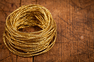 Golden rope on wooden table