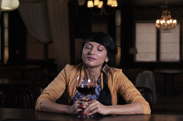 Young woman savouring a glass of red wine