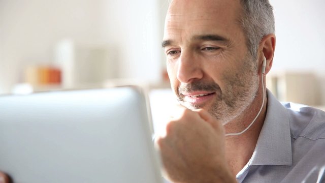 Businessman talking via internet with tablet
