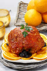 Pork served on oranges.