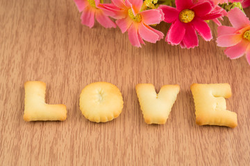 LOVE, Biscuits letters on wooden background