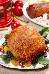 Baked pork with dried apricots on christmas table