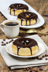 Delicious donut with chocolate on wooden table