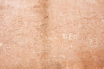 Text scratched in an old brick wall