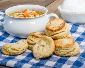 Chicken soup and biscuits on table