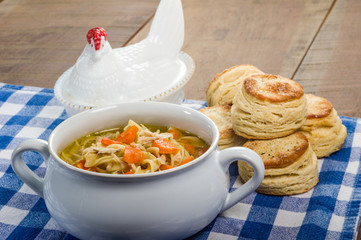 Chicken soup and biscuits on table