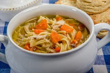 Chicken soup and biscuits on table