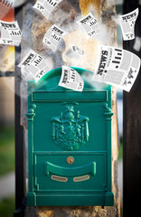 Post box with daily newspapers flying