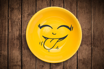 Happy smiley cartoon face on colorful dish plate