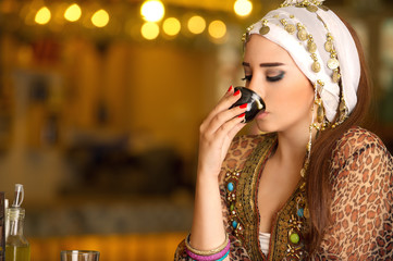 Beautiful Arabian model drinking coffee