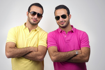 Identical twins portraits shot against white background