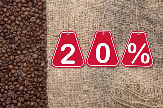 Twenty percent discount and coffee beans on a old burlap backgro