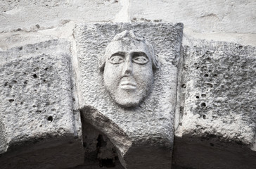 Bas-relief of a man's face on ancient house facade in Perast tow