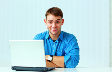 Young smiling casual businessman in blue shirt 