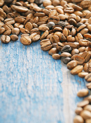 Coffee beans on blue wooden background