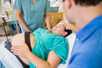 Loving Husband Wiping Pregnant Wife's Forehead