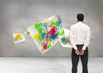 Fototapeta premium Composite image of rear view of young businessman wearing handcu