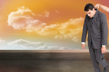 Obraz premium Composite image of businessman hanging