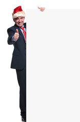 business man with santa hat is making ok sign while holding a bo