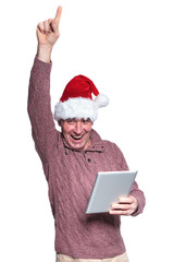 old casual man with santa hat is winning while holding a tablet