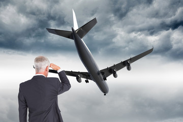 Composite image of rear view of mature businessman looking away