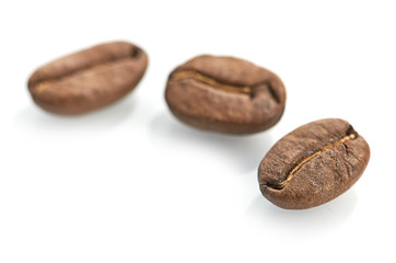 Macro of coffee beans isolated on white background