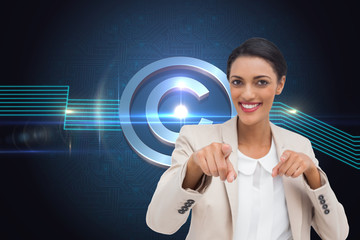 Composite image of smiling businesswoman pointing at the camera