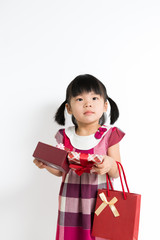 Toddler girl with gift box and bag