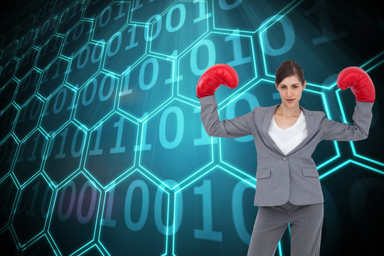 Composite image of businesswoman with boxing gloves - Powered by Adobe