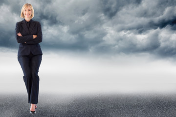 Composite image of friendly businesswoman smiling at the camera