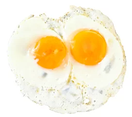 Keuken foto achterwand Spiegeleieren bovenaanzicht van twee bak eieren op wit
