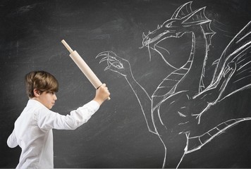 Brave boy fighting a dragon