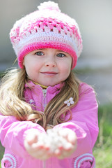 beautiful little girl near a flowering tree