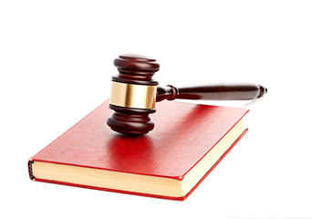 Judge's gavel on red legal book