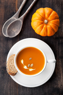 Pumpkin soup with pumpkin seeds in a white mug