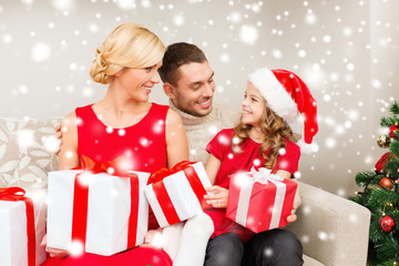smiling family holding many gift boxes